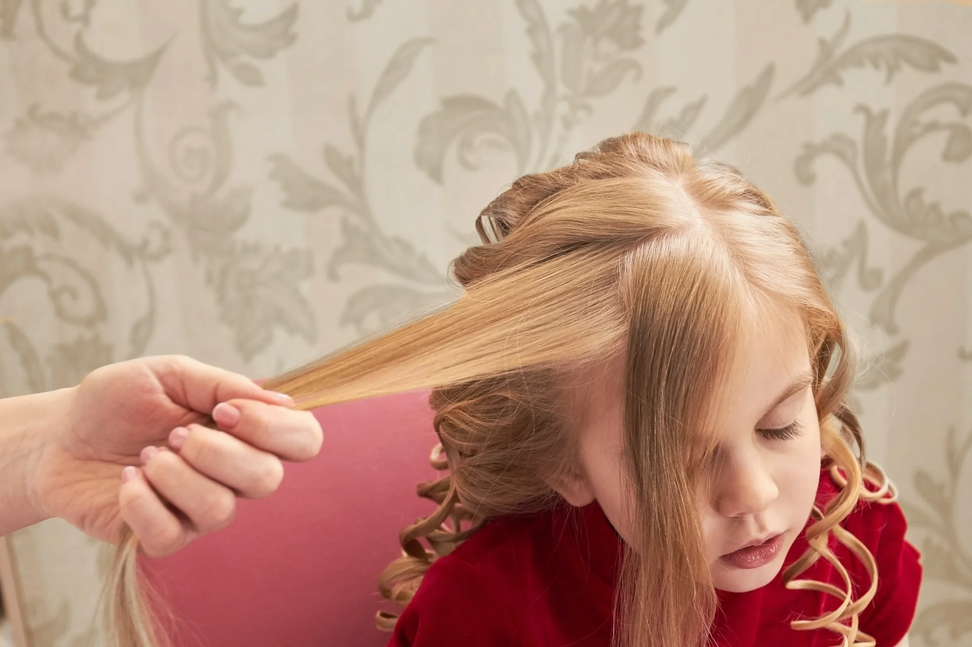 Hand holding hair of child